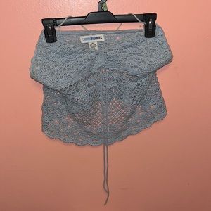 Brand is Canyon River Blues.  Color is a light blue. Tube top/ halter top.